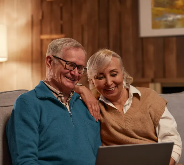 A couple reviewing their retirement options on a laptop